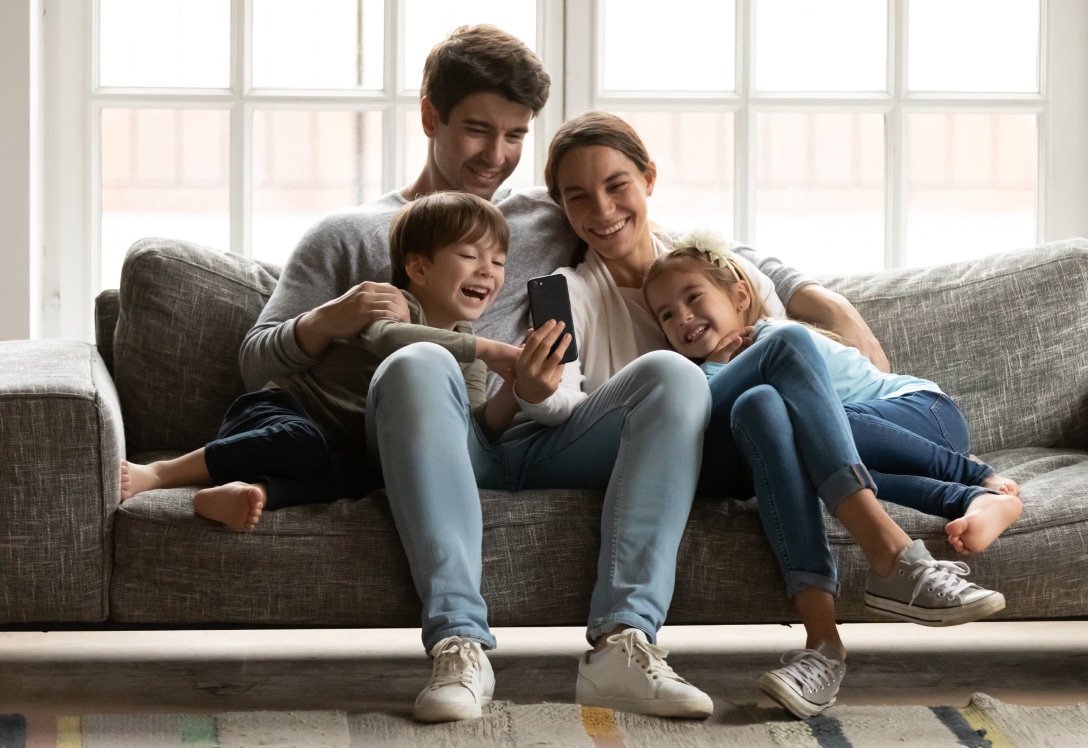 Familia mira el móvil en el salón